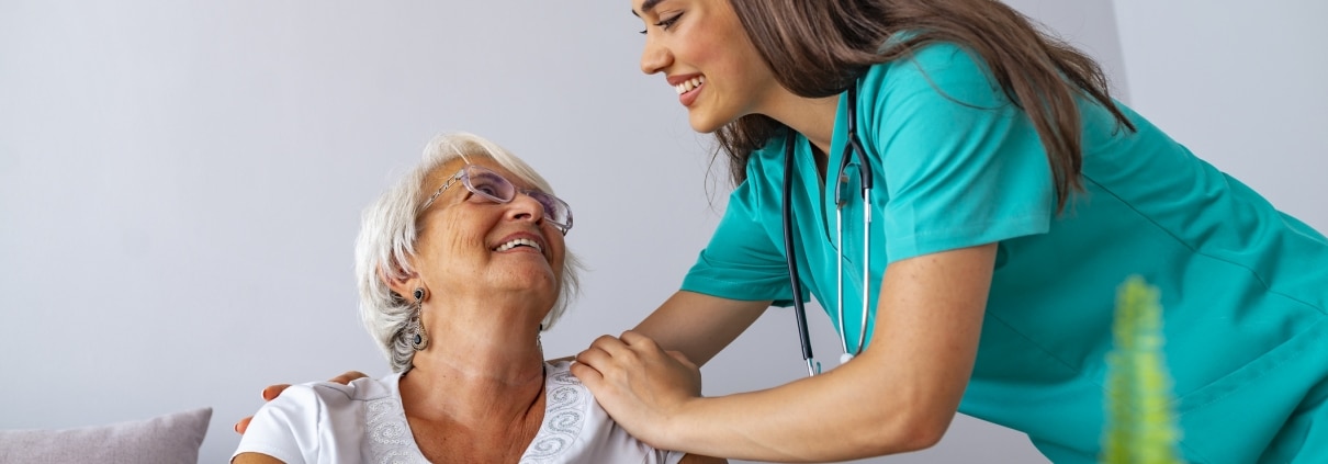 Nurse caring for elderly woman