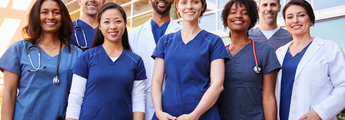 Smiling medical team standing outside