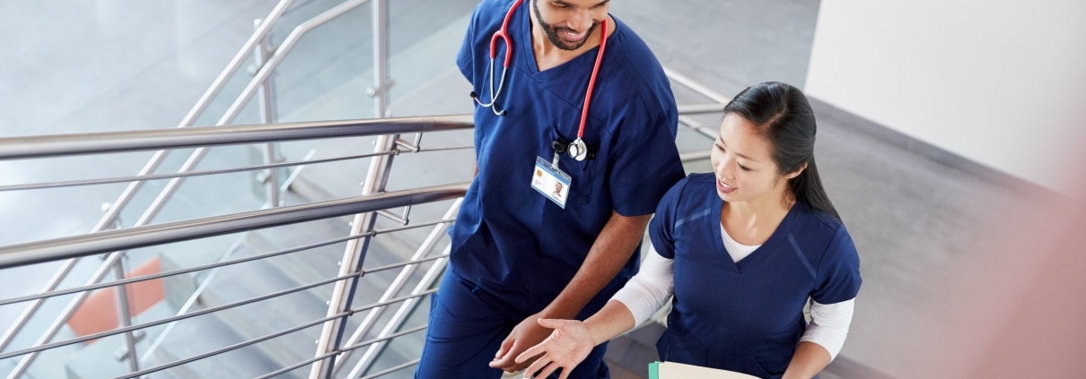 Two medical professionals on a staircase