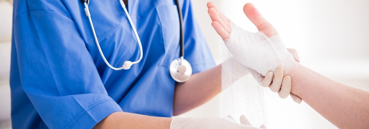 Close up of a nurse wrapping a wound
