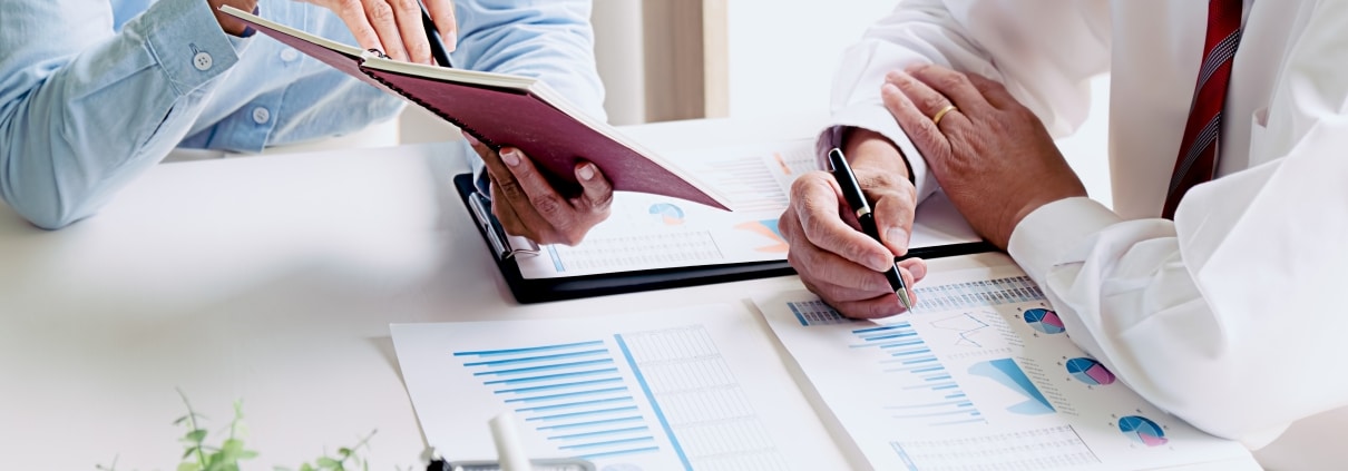 Close up of business professionals reviewing paperwork