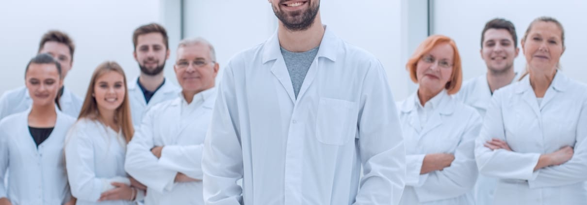 Group of smiling medical professionals in white coats