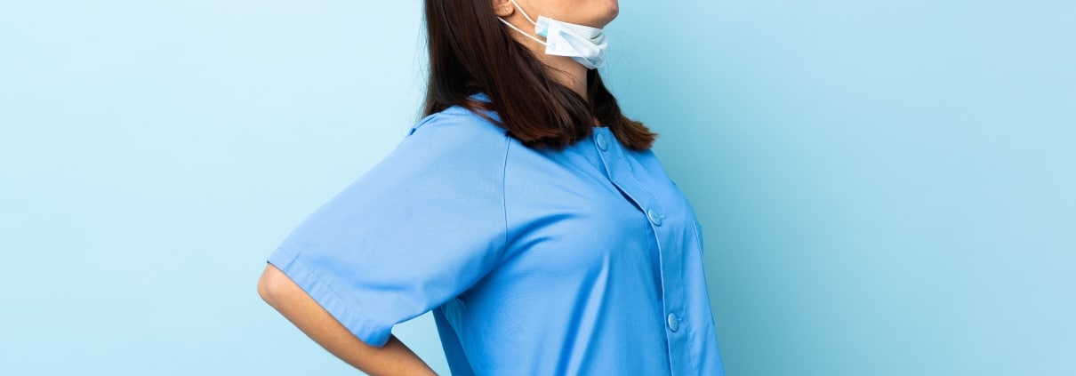 Nurse with glasses touching her back in pain