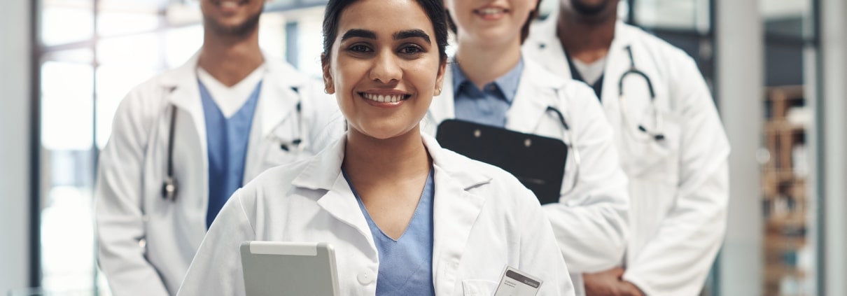 Smiling group of healthcare professionals in a staggered line