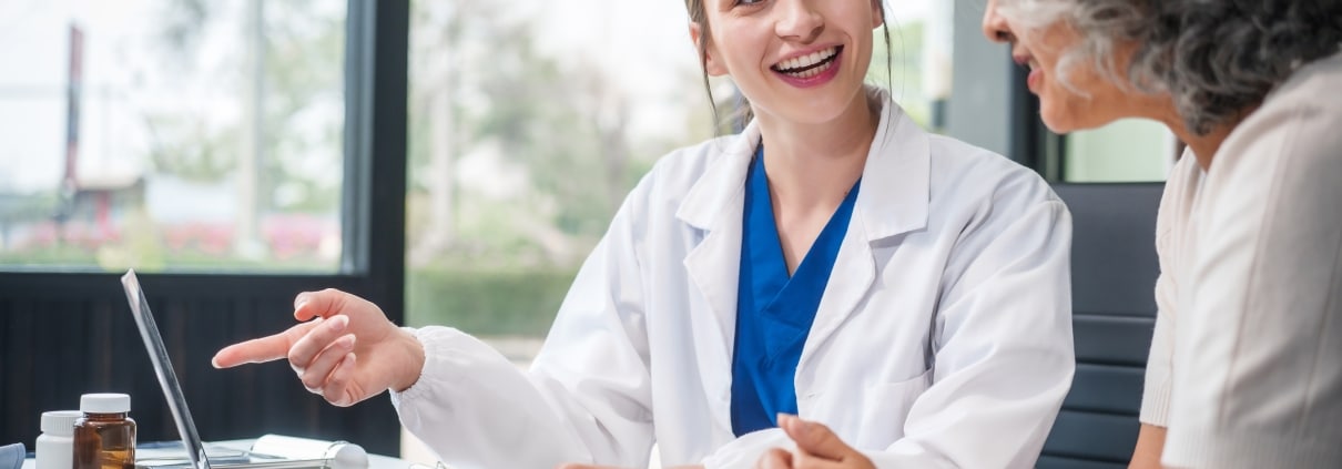 Caucasian medical professional speaking with an older patient
