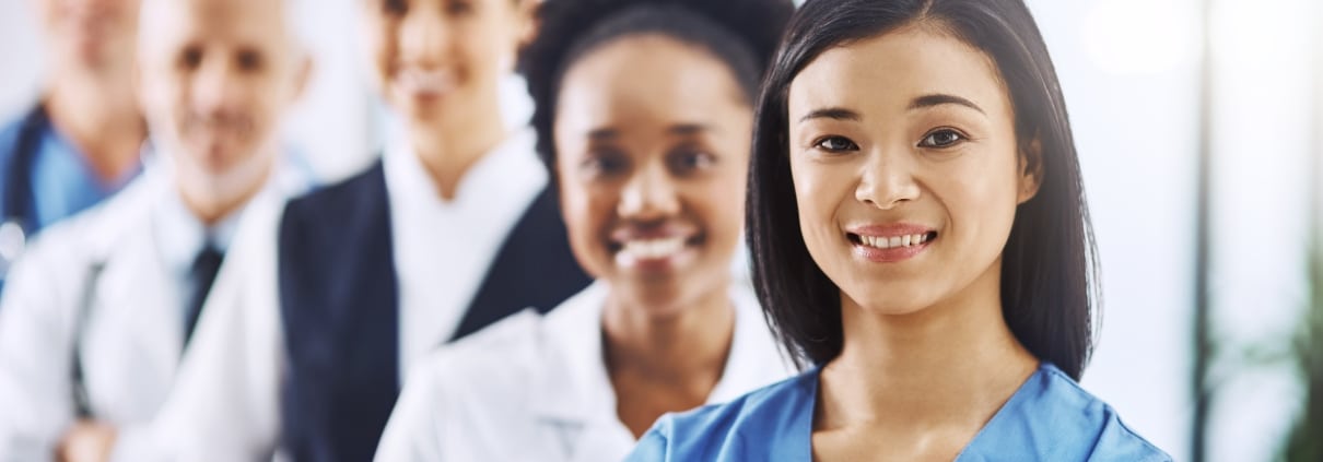 Team of diverse medical professionals standing in a line