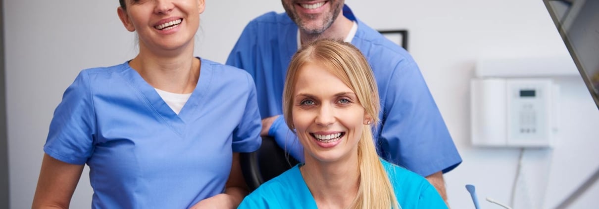 Group of smiling medical professionals in scrubs